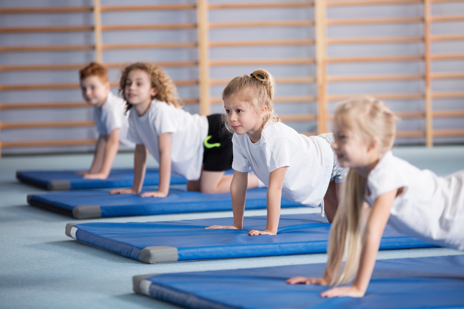 A gymnastics coach guiding a girl through her routine
